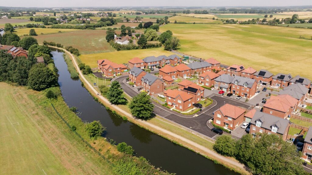 Aerial view of the completed Bridgemere development beside the Leeds and Liverpool Canal in Burscough
