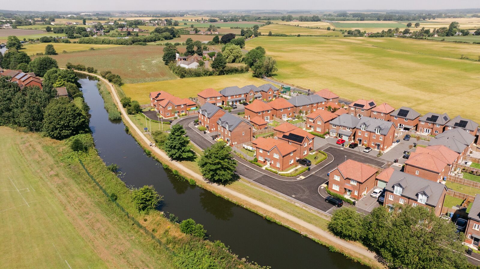 Aerial view of the completed Bridgemere development beside the Leeds and Liverpool Canal in Burscough
