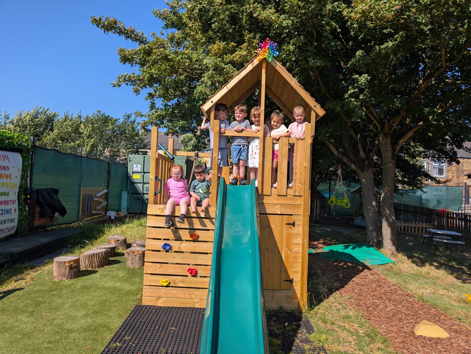 Children enjoying their new climbing frame at Happy Faces Childcare